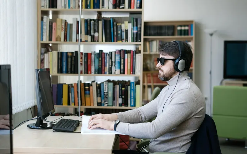 A describer recording an audio description track in a studio