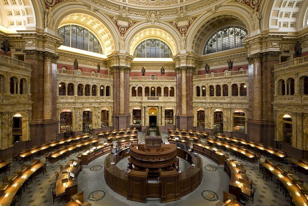 The Great Hall of the Library of Congress, its arcaded marble staircases rising beneath a painted vaulted ceiling.