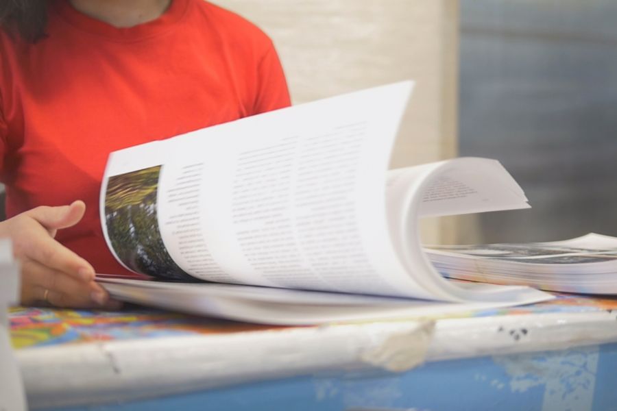 Transcriber adjusting a large print layout on screen