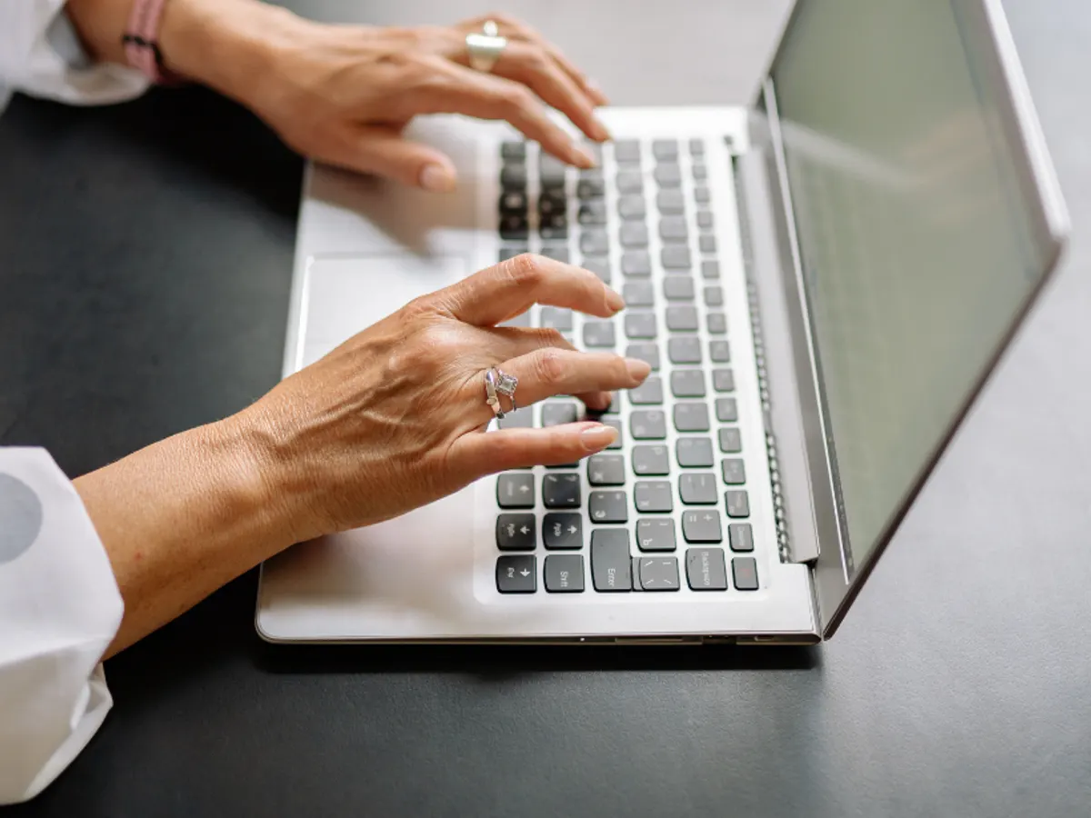 Someone filling in the service request form on a laptop