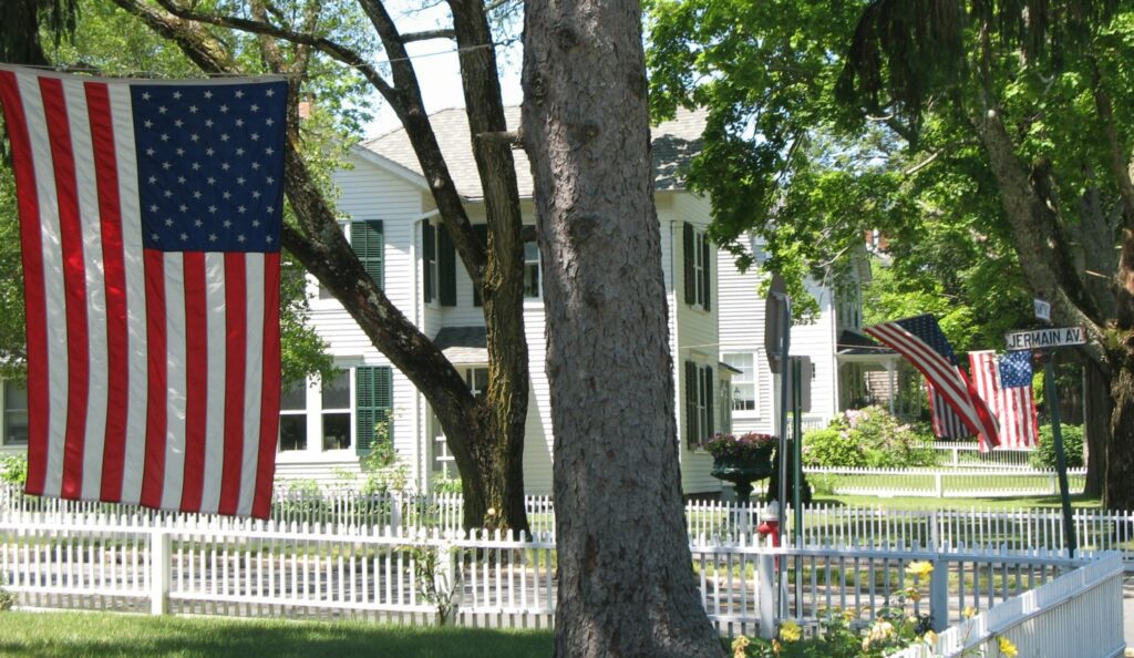 Sag Harbor's main street of clapboard shopfronts running down toward the masts in the marina.