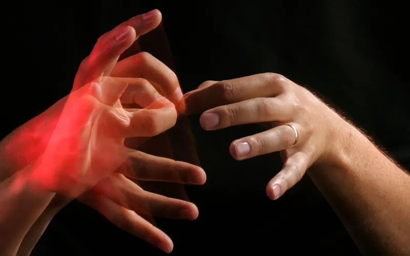 A sign language interpreter signing to an audience from a stage